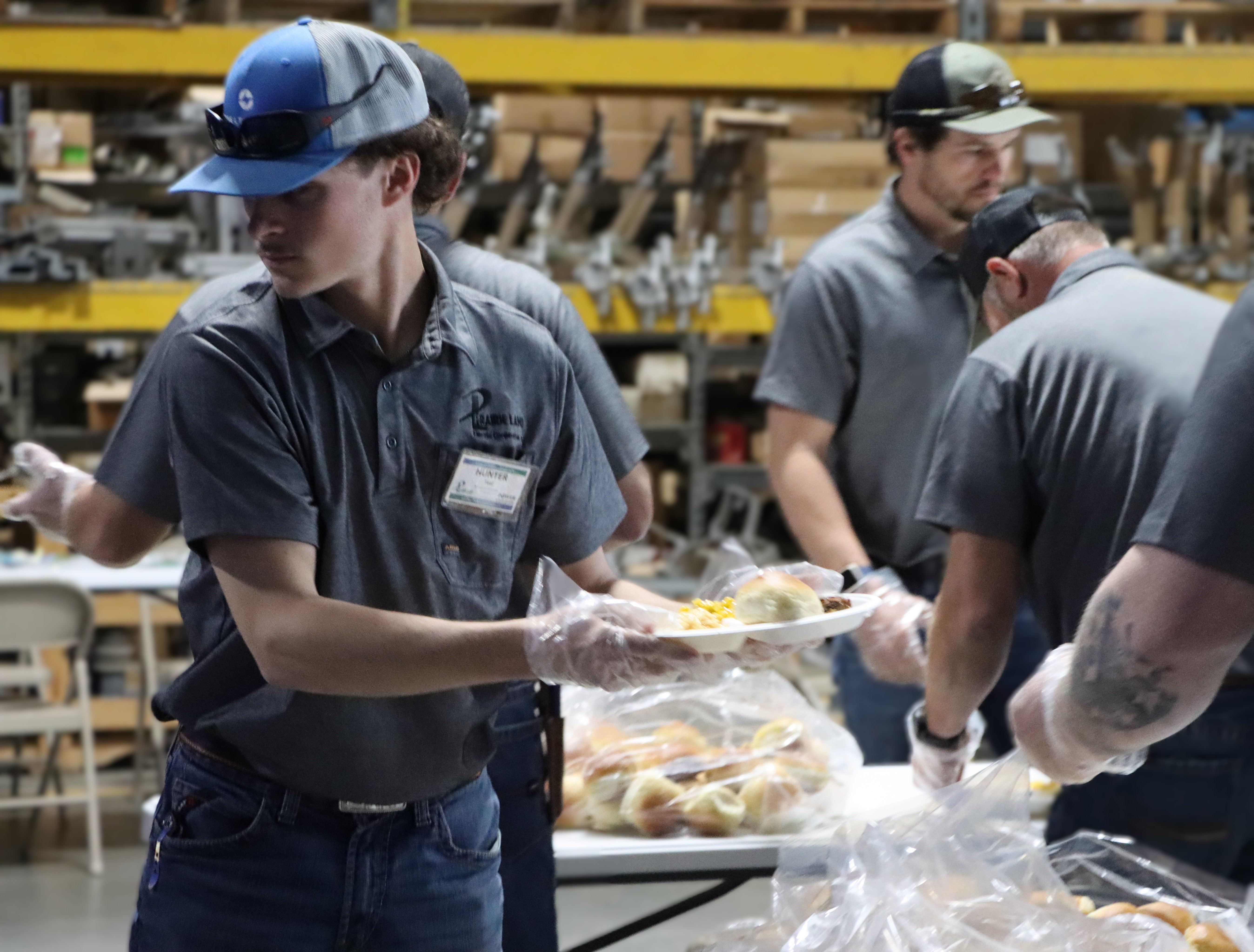 Linemen step in to serve, plating meals for attendees.